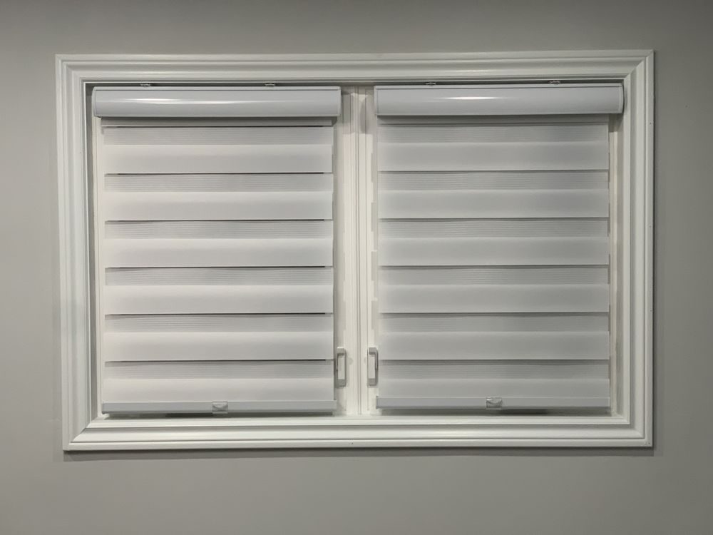 White zebra blinds installed in a window with white trim